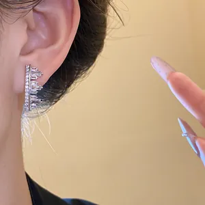 Detail macro view of irregular geometric zircon ear cuff with sparkling baguette stones