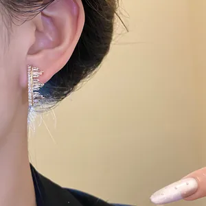 Elegant gold-tone irregular geometric zircon ear clip displayed on a model's ear