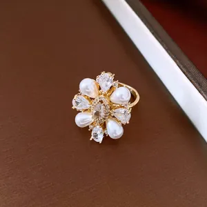 Detail view of a vintage 14k gold plated pearl and zircon floral ring with elegant luster.