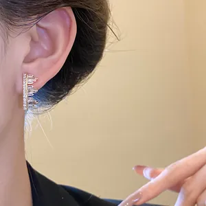 Close-up of irregular geometric zircon ear clip worn on ear with elegant gold finish