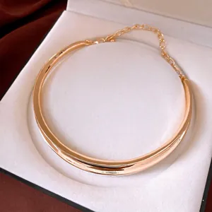 Elegant gold plated pleated metallic choker necklace displayed in a luxury jewelry gift box