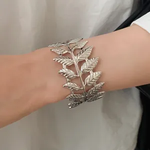 Elegant close-up of a vintage silver metal leaf texture open cuff bracelet on wrist