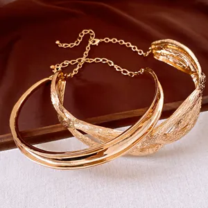 Close-up view of golden irregular metal pleated twisted necklace with exquisite texture