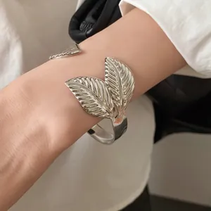 Detailed view of vintage silver leaf textured open cuff bracelet for elegant women