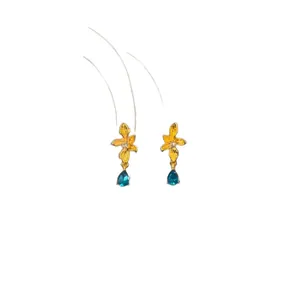 Elegant golden flower earrings with blue teardrop zircon charms on white background