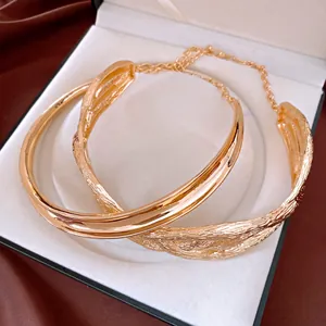 Detail shot of golden irregular pleated metal necklace in a display box