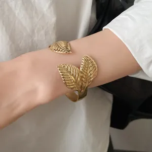 Detailed view of the intricate leaf texture on this vintage gold cuff bracelet.