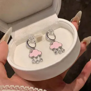 Detailed close-up of pink enamel cloud clip-on earrings with sparkling zircon teardrop charms