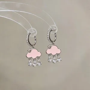 Close-up detail of sweet pink enamel cloud clip-on earrings with zircon raindrops