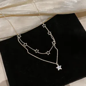 Elegant double-layer gold star pendant necklace featuring a sparkling zircon detail
