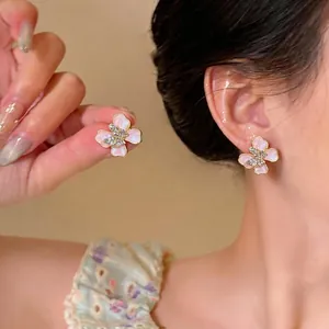 Refined pink butterfly flower stud earrings with sparkling rhinestones and gold-tone finish