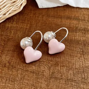 Sweet pink heart and pearl drop earrings with silver hooks for women.