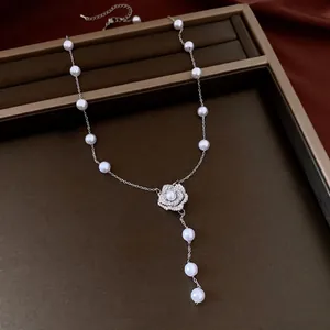Elegant vintage pearl necklace with a sparkling zircon flower pendant, silver-toned