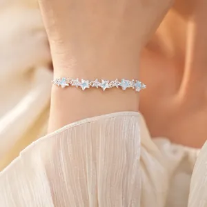 Close-up detail of silver-tone bracelet with sparkling zircon star charms
