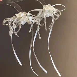 Exquisite close-up of white fabric flower pearl tassel choker with ribbon detail