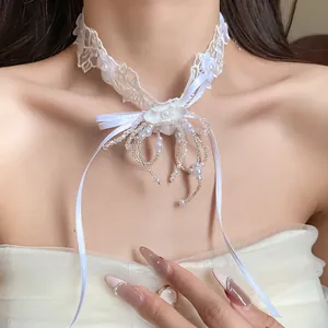 Elegant white lace choker necklace featuring a central flower and delicate pearl tassels