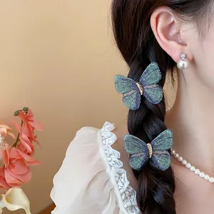 Close-up view of elegant embroidered butterfly hair clips styled on a delicate braided hairstyle