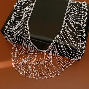 Close-up detail of a vintage style glass bead fringe collar necklace on black box
