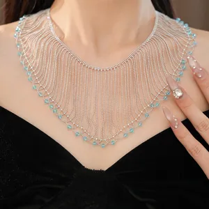 Detailed close-up of a luxurious silver fringe necklace adorned with blue glass beads.