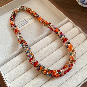 Handmade colorful woven rainbow beaded choker necklace displayed in a jewelry box