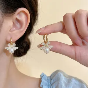 Elegant 18k gold plated bow earrings with white pearl drop and sparkling zircon