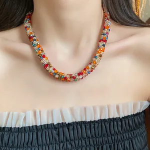 Colorful handmade rainbow beaded necklace on model, elegant collarbone chain style.
