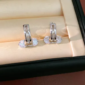 Macro view of 18K gold plated hollow hoop earrings with elegant cubic zirconia stones