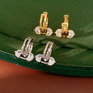 Elegant 18K gold-plated oval hollow hoop earrings featuring sparkling zircon inlay.