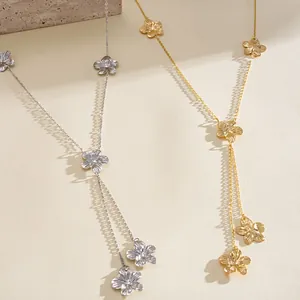 Detailed view of gold and silver metal flower tassel necklaces with retro design.