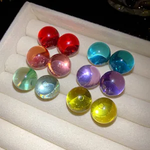 Detailed view of colorful translucent resin sphere stud earrings in display tray