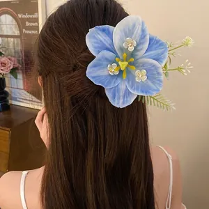 Elegant large blue lily flower hair clip for women with romantic spring aesthetic