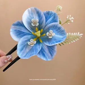 Elegant blue lily hair clip with sparkling rhinestone centers for a spring fairy look