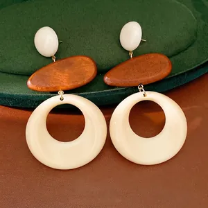 Vintage geometric drop earrings featuring natural wood and cream resin hoops for a retro look