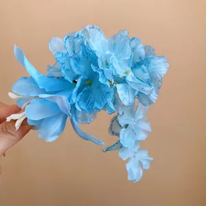 Detail view of a light blue artificial lily floral hair clip with spring aesthetic.