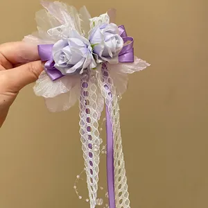 Close-up of elegant purple silk roses and white lace ribbon hair clip with pearl beads