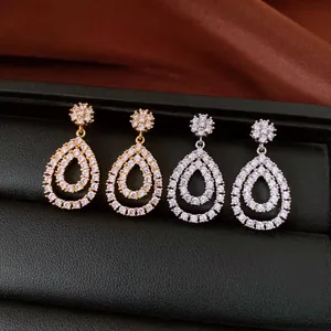 Detailed macro view of teardrop dangle earrings with sparkling cubic zirconia pavé