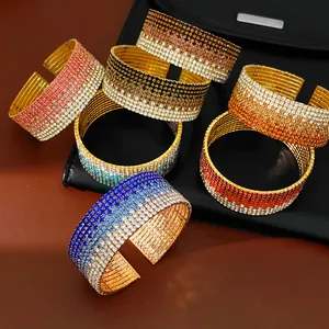 Dettaglio macro di bracciali rigidi elastici multistrato con strass a gradiente