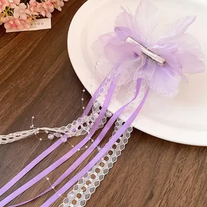Detailed back view of purple lace flower hair clip with silk ribbons and duckbill clip