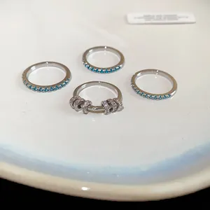 Detailed macro view of mint green zircon eternity rings and a silver beaded ring.