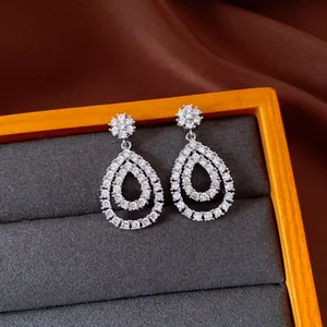Detailed close-up of teardrop drop earrings featuring sparkling cubic zirconia stones