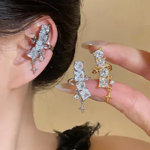 Detailed view of elegant gold and silver star ear clips with sparkling cubic zirconia