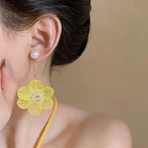 Sweet yellow flower drop earrings with pearl studs for a refreshing summer look.