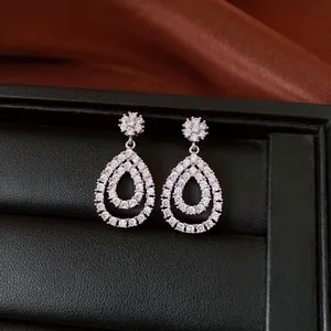Macro detail of teardrop zirconia dangle earrings with elegant 18K gold plating finish