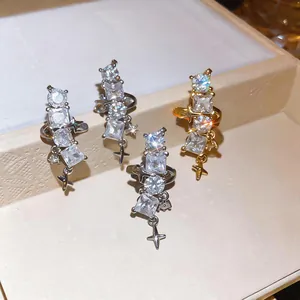 Detailed view of sparkling zircon star ear clips in silver and gold for non-pierced ears