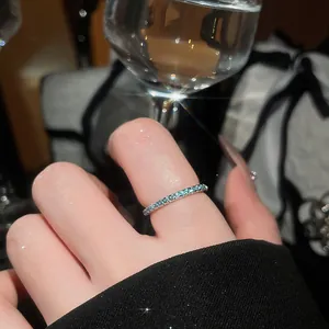 Elegant close-up of a thin mint green zircon eternity ring with sparkling light reflections