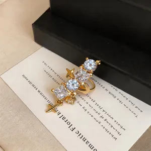 Detail shot of elegant gold-plated star ear cuff with multi-shape cubic zirconia