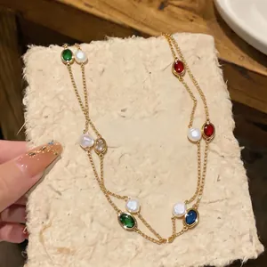 Layered gold necklace featuring colorful oval zircon stones and natural freshwater pearls