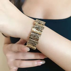 Close-up detail of vintage gold geometric irregular textured metal bracelet on wrist