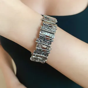 Close-up detail of a vintage silver irregular geometric metal bracelet on a wrist