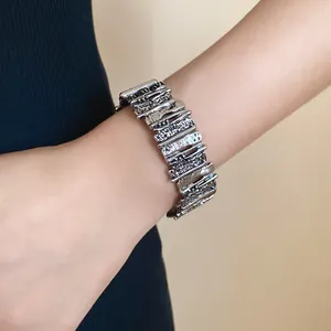 Detailed view of a vintage silver-finish geometric irregular textured metal bracelet.